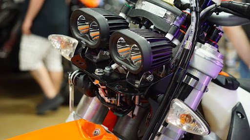 This close-up shows a motorcycle with dual high-output LED headlights, designed for durability and enhanced visibility in off-road or low-light conditions.